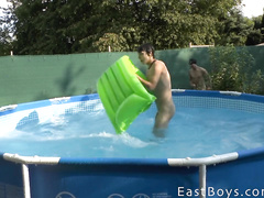 Some twink is filming two sexy gays having fun in the pool